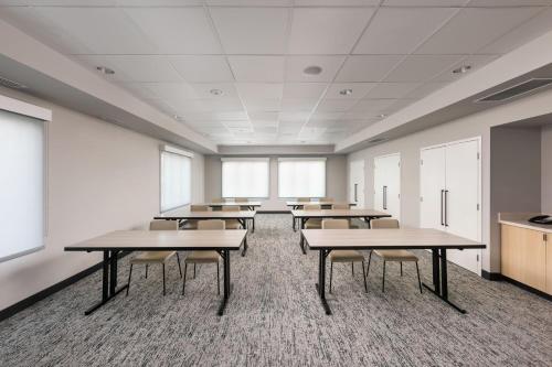 a classroom with tables and chairs in a room at TownePlace Suites by Marriott West Kelowna in West Kelowna