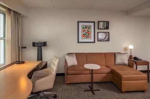 a living room with a couch and a table at Residence Inn by Marriott Norfolk Airport in Norfolk