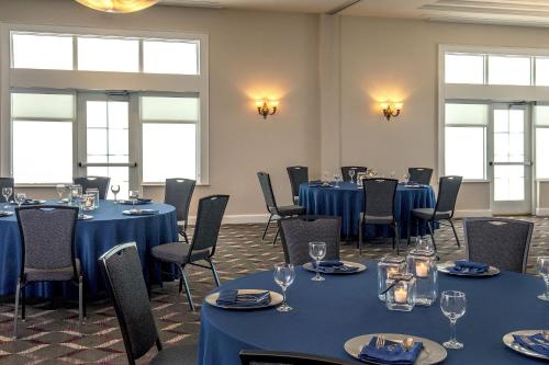a room with blue tables and chairs and windows at Residence Inn by Marriott Norfolk Airport in Norfolk