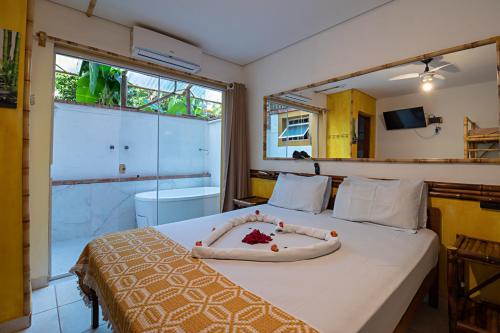 um quarto com uma cama com uma flor em Hotel Pousada Natural em Brotas