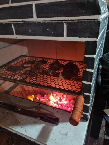 a brick oven with some food in it at Casa Ferreira Cumbuco in Caucaia