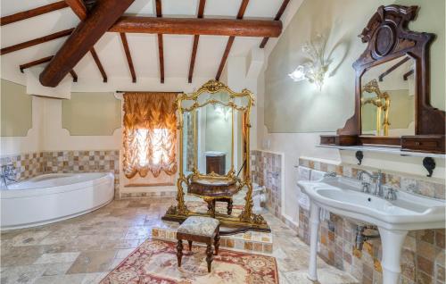 a bathroom with a tub and a sink and a mirror at Villa Pieve, Lucignano in Lucignano