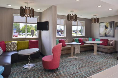 a waiting room with a couch and chairs and tables at Residence Inn by Marriott Cedar Rapids South in Cedar Rapids