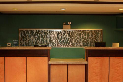 a bar in a restaurant with a green wall at Fairfield Inn & Suites by Marriott Fairmont in Fairmont