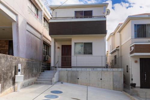 an image of a house with a building at Y's沖縄リゾートベースNo.3 in Onna