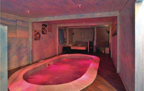 a large red bath tub in a room with a bedroom at 5 Bedroom Beautiful Home In Torre Di Pescopaganoce in Castel Volturno