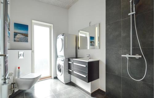 a bathroom with a sink and a washing machine at Amazing Home In Vggerlse With Wifi in Marielyst