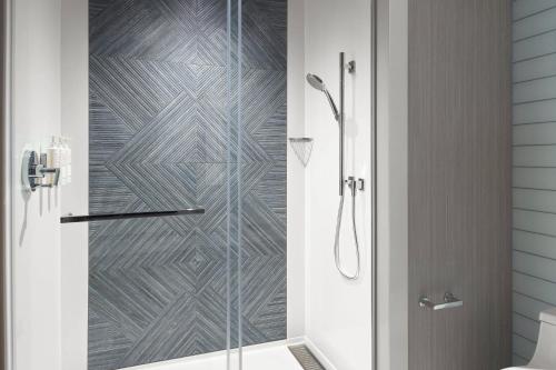 a shower with a glass door in a bathroom at Lexington Marriott City Center in Lexington
