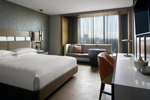 a hotel room with a bed and a couch at Lexington Marriott City Center in Lexington