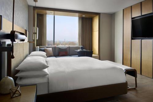 a bedroom with a large white bed and a television at Lexington Marriott City Center in Lexington