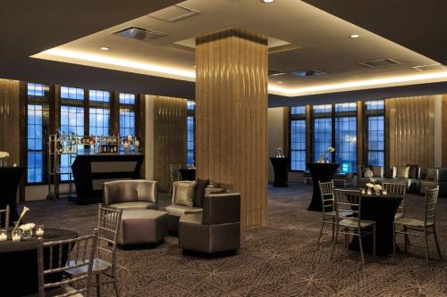 a lobby of a hotel with tables and chairs at Renaissance Cincinnati Downtown Hotel in Cincinnati