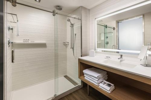 a bathroom with a sink and a shower at AC Hotel by Marriott Washington DC Downtown in Washington