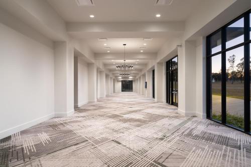 a hallway of a building with a tile floor at Sheraton Flowood The Refuge Hotel & Conference Center in Flowood