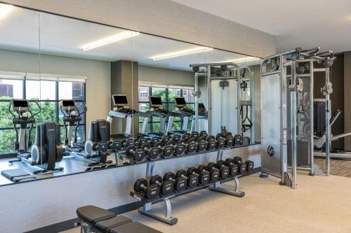 a gym with a large mirror and lots of equipment at Renaissance Oklahoma City Downtown Bricktown Hotel in Oklahoma City