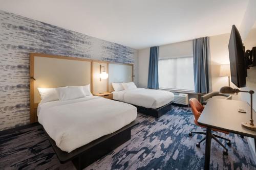 a hotel room with two beds and a desk at Fairfield by Marriott Inn & Suites Virginia Beach Town Center in Virginia Beach