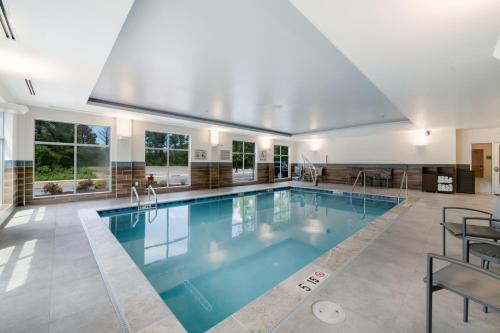 a large swimming pool with blue water in a house at Fairfield by Marriott Inn & Suites Virginia Beach Town Center in Virginia Beach