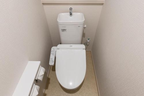 a bathroom with a white toilet in a stall at Y's沖縄リゾートベースNo.3 in Onna