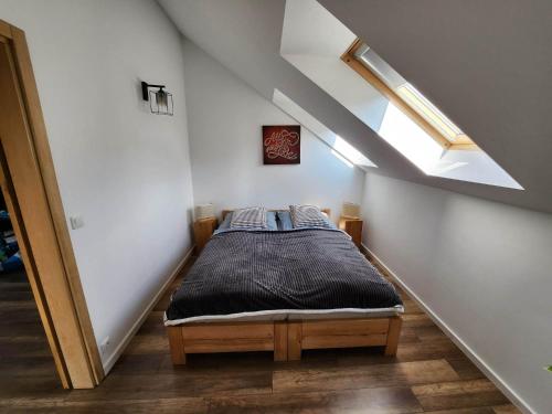 a small bedroom with a bed in a attic at Apartament u Ewki in Rdzawka