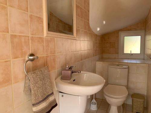 a bathroom with a white toilet and a sink at Sunrise Villa 11 in Ayia Thekla in Ayia Napa