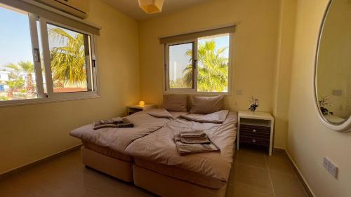 a bedroom with a bed with two towels on it at Sunrise Villa 11 in Ayia Thekla in Ayia Napa