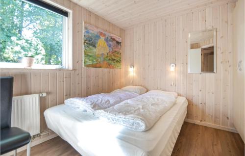 a bedroom with a bed in a room with a window at Beautiful Home In Ebeltoft With Sauna, Wifi And Indoor Swimming Pool in Ebeltoft