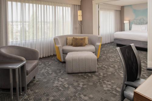 ein Hotelzimmer mit einem Schlafzimmer und einem Bett in der Unterkunft Courtyard by Marriott Portland Airport in Portland