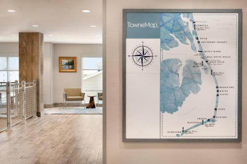 a map hanging on a wall in a hallway at TownePlace Suites by Marriott Outer Banks Kill Devil Hills in Kill Devil Hills