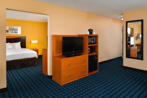 a hotel room with a bed and a flat screen tv at Fairfield Inn & Suites by Marriott Helena in Helena
