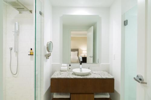 a bathroom with a sink and a shower at The Ritz-Carlton Residences, Turks & Caicos in Providenciales