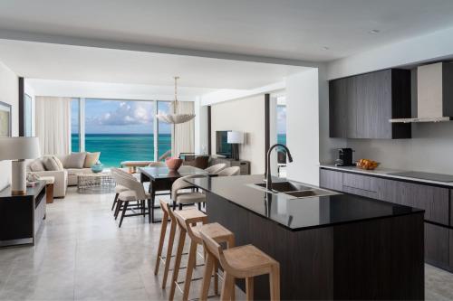 a kitchen and living room with a view of the ocean at The Ritz-Carlton Residences, Turks & Caicos in Providenciales