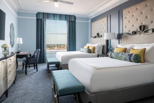 a hotel room with two beds and a desk at The Ritz-Carlton, New Orleans in New Orleans