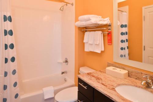 a bathroom with a shower toilet and a sink at TownePlace Suites by Marriott Huntsville West/Redstone Gateway in Huntsville