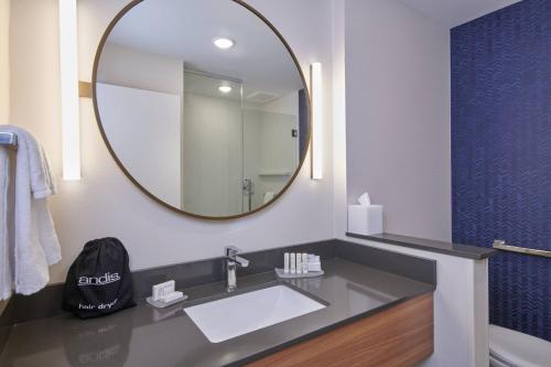 a bathroom with a sink and a mirror at Fairfield Inn & Suites by Marriott Louisville Jeffersonville in Jeffersonville