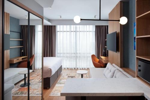 Habitación de hotel con cama y sala de estar. en Residence Inn by Marriott Istanbul Atasehir en Estambul