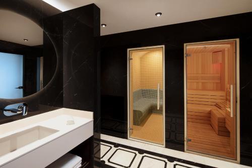 a bathroom with a sink and a glass shower at Residence Inn by Marriott Istanbul Atasehir in Istanbul