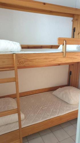 deux ensembles de lits superposés dans une chambre dans l'établissement ARCHIPEL III Agréable 2 pièces cabine piscine Richelieu Cap d'Agde, au Cap d'Agde