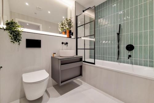 a bathroom with a toilet and a sink at Luxury Harrow Wembley Apartment in Harrow
