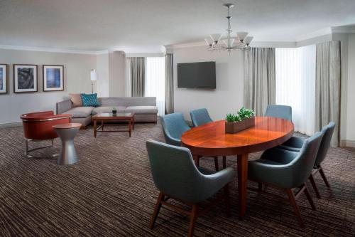 a living room with a table and chairs and a couch at Marriott Downtown at CF Toronto Eaton Centre in Toronto