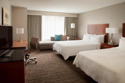 a hotel room with two beds and a television at Marriott Downtown at CF Toronto Eaton Centre in Toronto