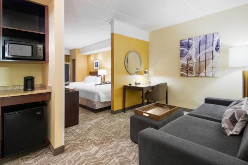 a hotel room with a bed and a living room at SpringHill Suites by Marriott Wheeling Triadelphia Area in Wheeling