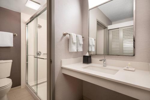 a bathroom with a sink and a mirror at Courtyard by Marriott Los Angeles Hacienda Heights Orange County in Hacienda Heights