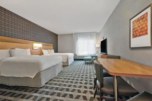 a hotel room with two beds and a desk at TownePlace Suites by Marriott Sacramento Elk Grove in Elk Grove