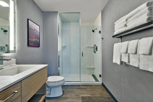 een badkamer met een douche, een toilet en een wastafel bij TownePlace Suites by Marriott Sacramento Elk Grove in Elk Grove