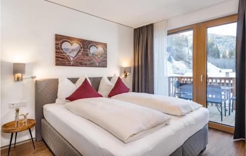 a hotel room with two beds and a balcony at Amazing apartment in Matrei in Osttirol with Sauna and 1 Bedrooms in Matrei in Osttirol
