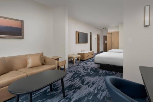 a hotel room with a couch and a bed at Fairfield Inn & Suites by Marriott Santa Rosa Rohnert Park in Rohnert Park