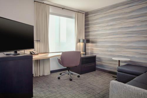 a room with a desk with a computer and a chair at Residence Inn by Marriott Loma Linda Redlands in Redlands
