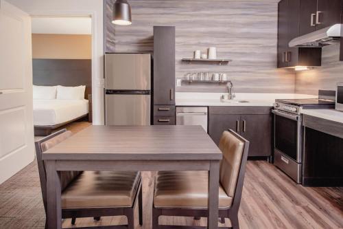 a kitchen with a table and chairs in a room at Residence Inn by Marriott Loma Linda Redlands in Redlands