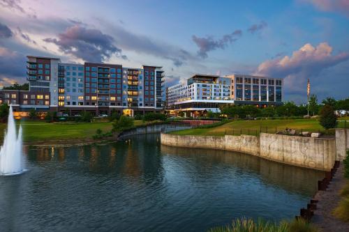 a view of a river with buildings and a fountain at AC Hotel by Marriott Tallahassee Universities at the Capitol in Tallahassee