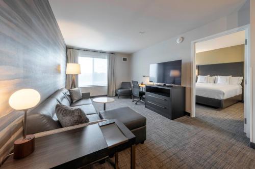 a hotel room with a couch and a bed at Residence Inn by Marriott Richmond at the Notch in Richmond
