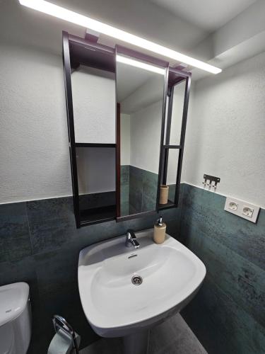 a bathroom with a white sink and a mirror at B&B Finca la Yuca "Un paraíso en Ontinyent" in Ontinyent
